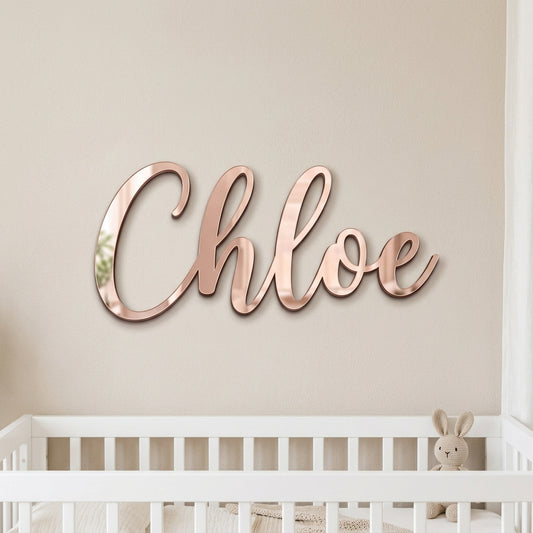 Mirror acrylic name sign on a bedroom wall